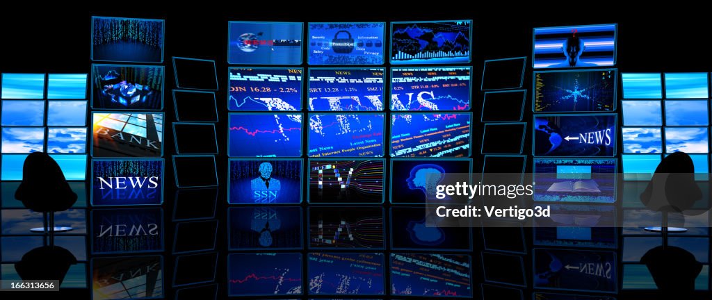 Multiple TV screens display news in a dark studio