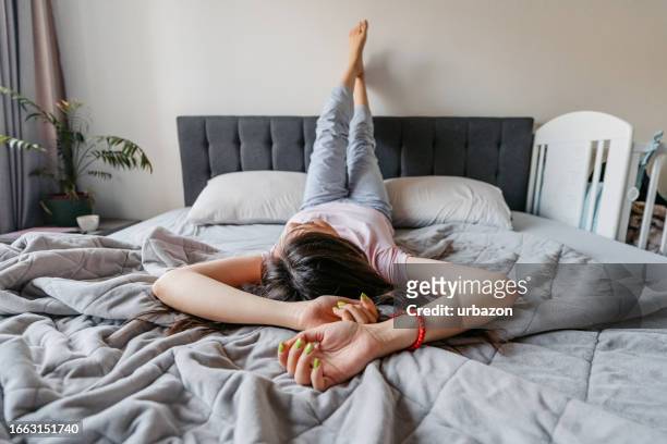 young woman lying in the bed in the morning - overslept stock pictures, royalty-free photos & images