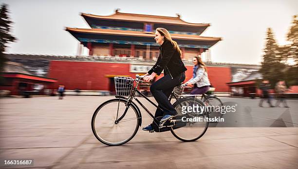 tourists in beijing riding bikes - chinese person stockfoto's en -beelden