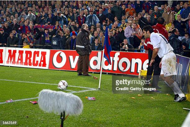 Luis Figo of Real Madrid is bombarded by missiles as he attempts to take a corner during the La Liga match between FC Barcelona and Real Madrid...
