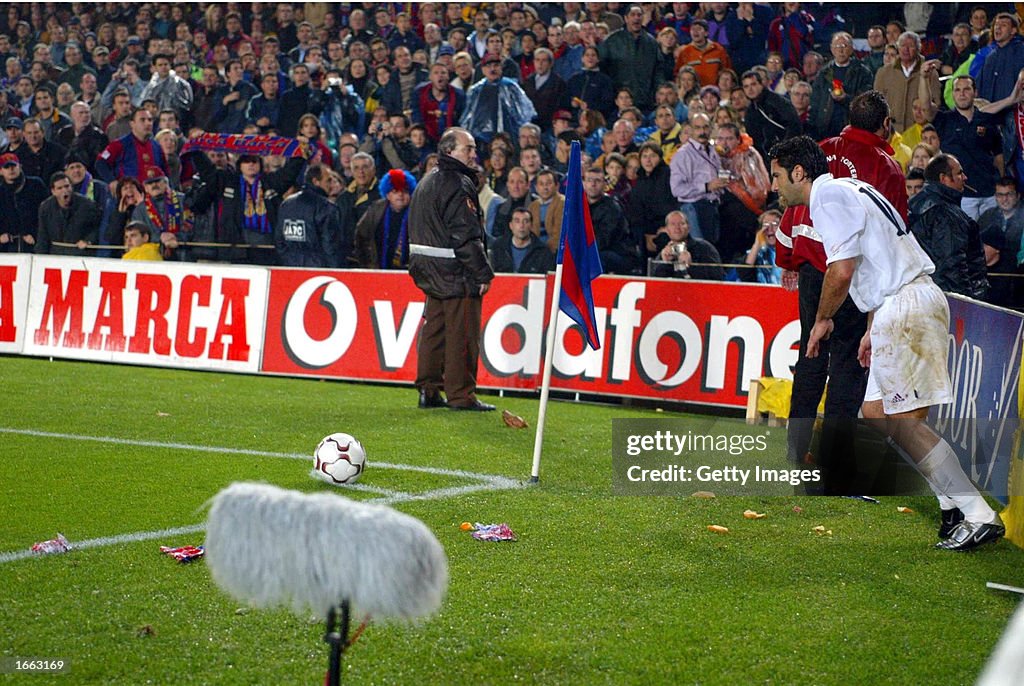 Luis Figo of Real Madrid is bombarded by missiles