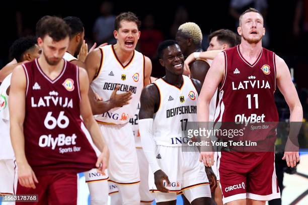 Moritz Wagner and Dennis Schroder of Germany celebrate after the FIBA Basketball World Cup quarterfinal victory as Kristers Zoriks and Rolands Smits...