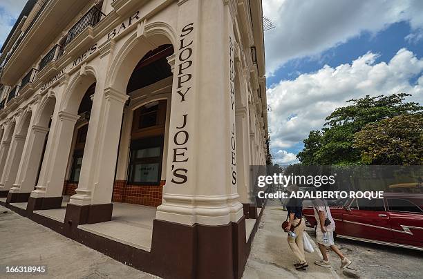 Tourists walk next to the newly renovated "Sloppy Joe's" bar in Havana, on April 11, 2013. "Sloppy" was one of the most famous places in the...