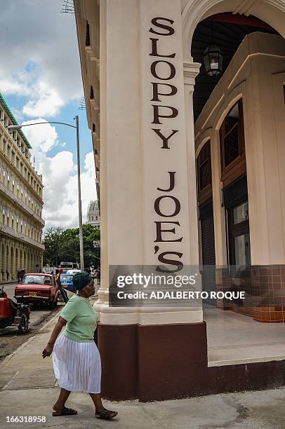 Woman walks next to the newly renovated "Sloppy Joe's" bar in Havana, on April 11, 2013. "Sloppy" was one of the most famous places in the...