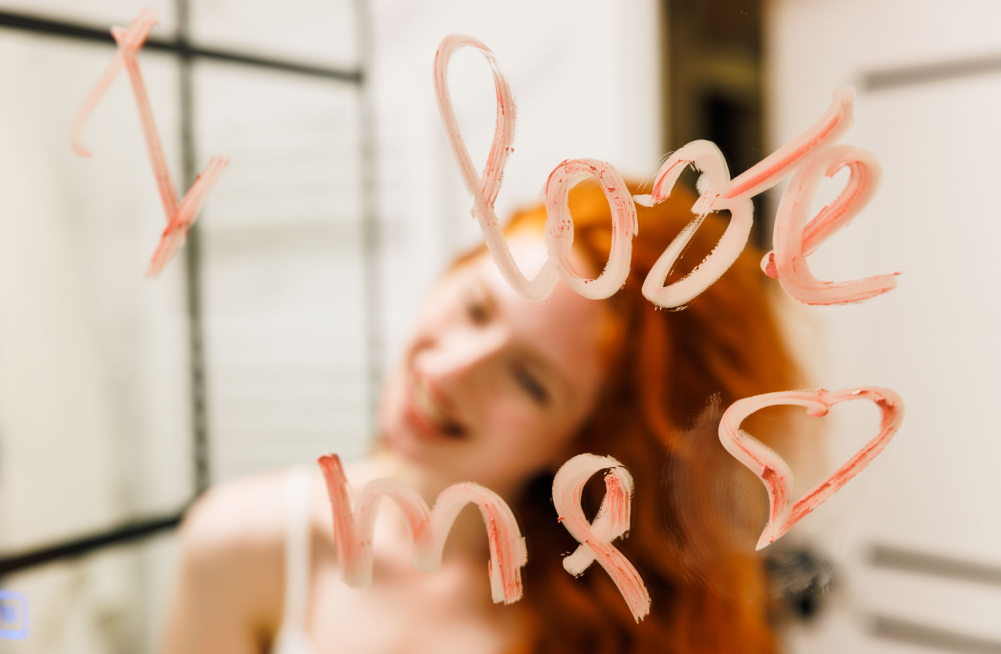 Redhead woman lipstick on the mirror and look at herself feeling confident self love. Love me true ...Inscription I LOVE ME Redhead woman lipstick on the mirror and look at herself feeling confident self love. Love me true ...Inscription I LOVE ME