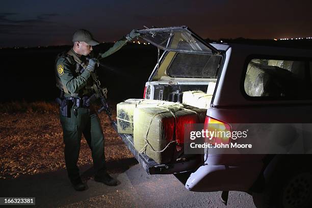 Border Patrol Agent inspects a load of marijuana seized from drug smugglers near the U.S.-Mexico border on April 10, 2013 in Hidalgo, Texas. The...