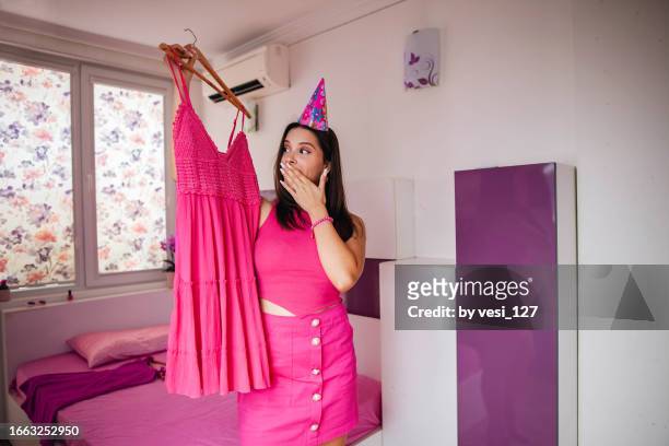 Gen Z Girl Wearing Hot Pink Clothes And High Heels Trying On A New