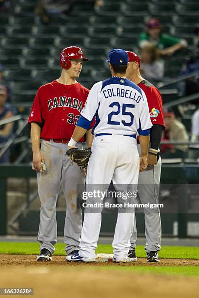 Justin Morneau and Larry Walker of Canada talks with Chris Colabello of Italy during the World Baseball Classic First Round Group D game on March 8,...