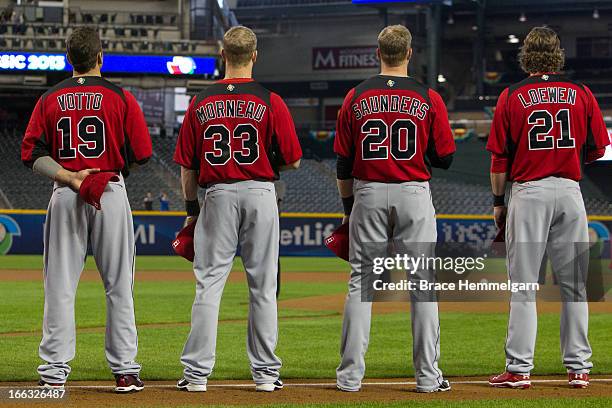 Joey Votto, Justin Morneau, Michael Saunders and Adam Loewen of Canada stand during the national anthem against Italy during the World Baseball...