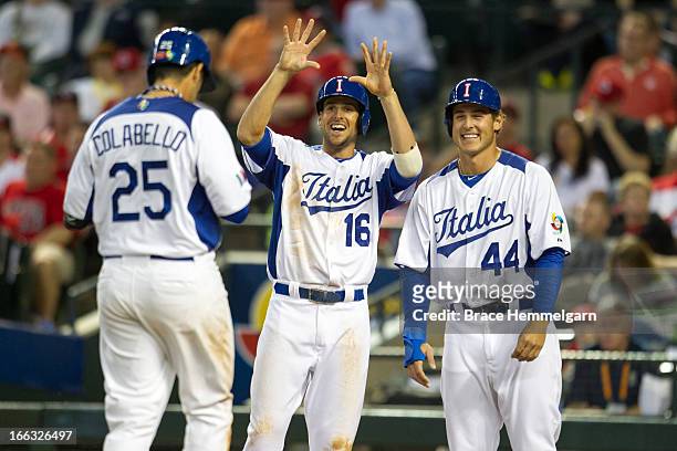 Alex Liddi and Anthony Rizzo of Italy celebrate a home run hit by Chris Colabello of Italy against Canada during the World Baseball Classic First...