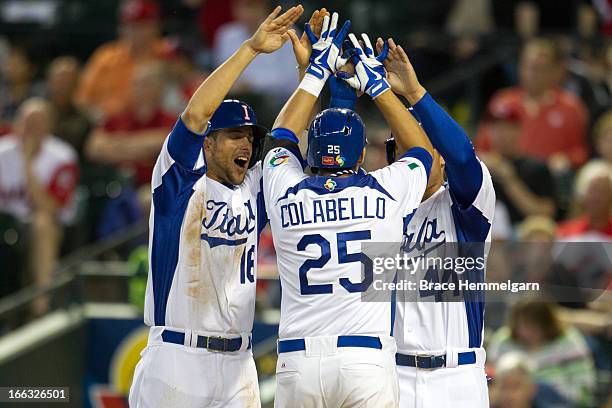 Alex Liddi and Anthony Rizzo of Italy celebrate a home run hit by Chris Colabello of Italy against Canada during the World Baseball Classic First...