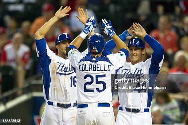 Alex Liddi and Anthony Rizzo of Italy celebrate a home run hit by Chris Colabello of Italy against Canada during the World Baseball Classic First...