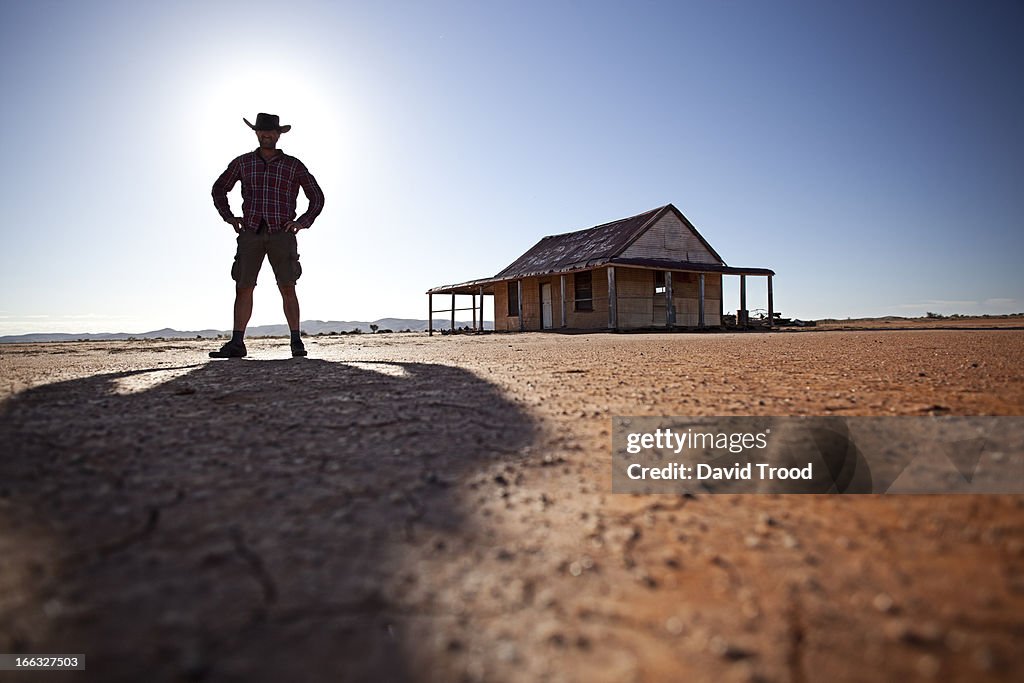 Man in front of outback shed