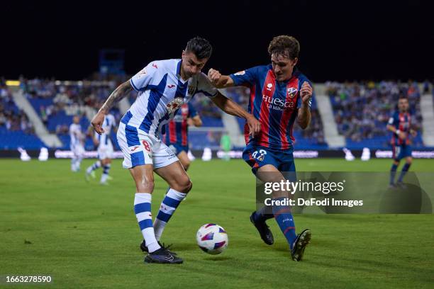 Luis Perea of CD Leganes and Iker Kortajarena of SD Huesca battle for the ball during the LaLiga Hypermotion match between CD Leganes and SD Huesca...