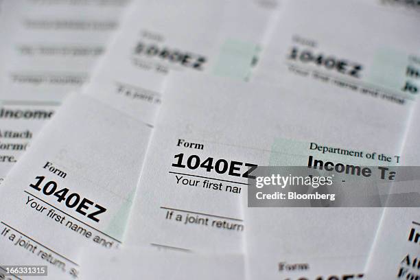 Department of the Treasury Internal Revenue Service 1040EZ Individual Income Tax forms for the 2012 tax year are arranged for a photograph in...