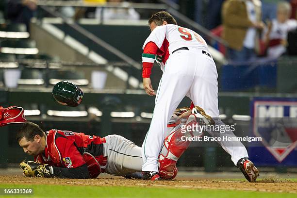 Karim Garcia of Mexico collides with Chris Robinson of Canada at home plate during the World Baseball Classic First Round Group D game on March 9,...