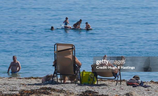 Beachgoers enjoy the sun and sea on Gyllyngvase Beach on September 06, 2023 in Falmouth, Cornwall, England. The UK is experiencing a late summer...