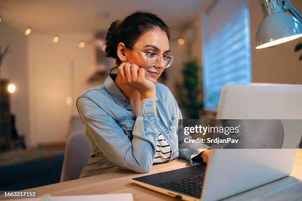 young caucasian woman, using laptop while working from home - e learning stock pictures, royalty-free photos & images