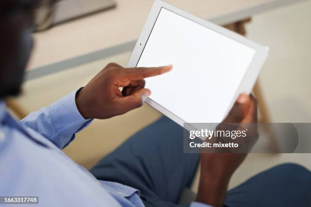 close up shot of young well dressed businessman using digital tablet with white screen on it - tablet close up real copyspace stock pictures, royalty-free photos & images