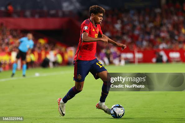 Lamine Yamal of Spain face an opponent during the UEFA EURO 2024