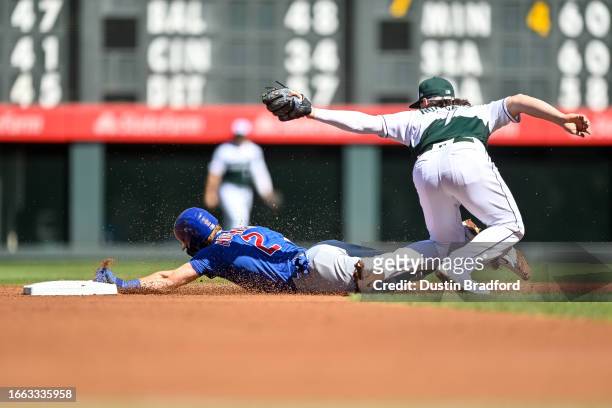 Nico Hoerner of the Chicago Cubs is tagged out by Brendan Rodgers of the Colorado Rockies after being caught stealing in the first inning at Coors...