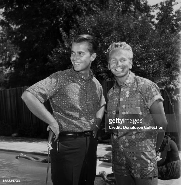 Show host Dick Clark and actor Kenny Miller at a pool party at Dick Clark's house in 1965 in Los Angeles, California .