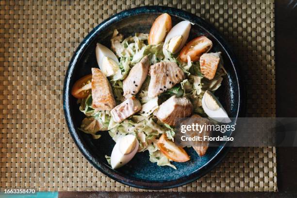 diet salad of tuna, eggs, green lettuce, arugula, seasoned with sesame seeds and mustard sauce. healthy nutrition, protein low-calorie diet, gluten free - tuna salad stock pictures, royalty-free photos & images