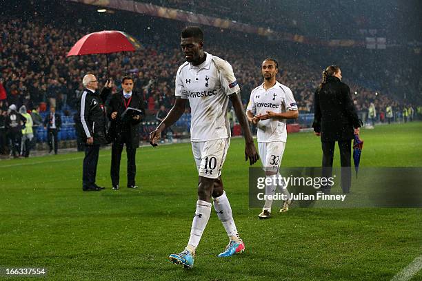 Dejected Spurs teammates Emmanuel Adebayor and Benoit Assou-Ekotto walk off the pitch following their team's defeat in the penalty shoot out during...