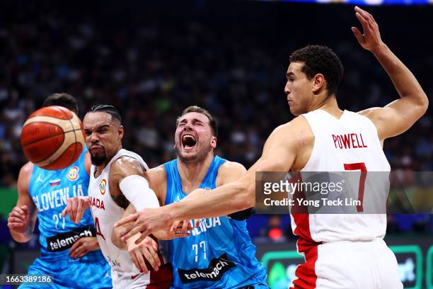Luka Doncic of Slovenia loses control of the ball against Dillon Brooks and Dwight Powell of Canada in the second quarter during the FIBA Basketball...