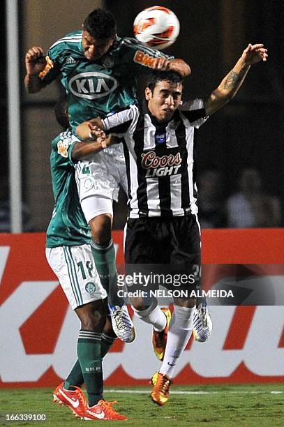 Mauricio Ramos of Brazil´s Palmeiras vies for the ball with Jose Ariel Nunez of Paraguay’s Libertad during their 2013 Copa Libertadores football...