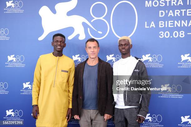 Seydou Sarr, Matteo Garrone and Moustapha Fall attend a photocall for "Io Capitano" at the 80th Venice International Film Festival on September 06,...