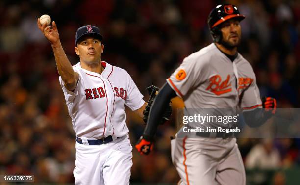 Alfredo Aceves of the Boston Red Sox throws out Nick Markakis of the Baltimore Orioles, who hit a grounder back to Aceves, in the third inning at...