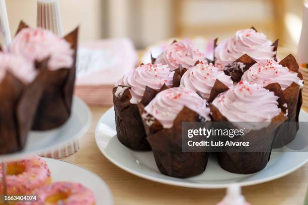 close-up of pink cupcake at gender reveal party table - cupcake stock pictures, royalty-free photos & images
