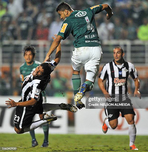 Mauricio Ramos of Brazil´s Palmeiras vies for the ball with Rodolfo Vicente Gamarra of Paraguay’s Libertad during their 2013 Copa Libertadores...