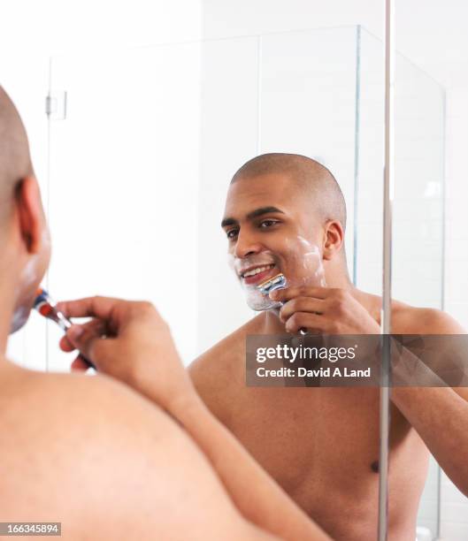man shaving in bathroom mirror - barbear imagens e fotografias de stock