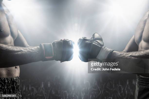 boxers touching gloves before fight - mixed martial arts stock-fotos und bilder