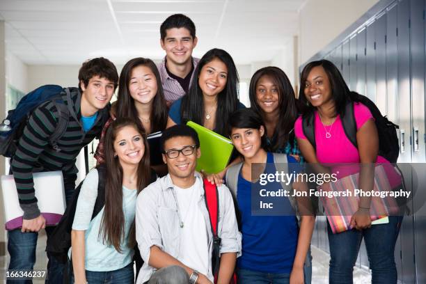 high school friends standing in corridor together - school fair stock pictures, royalty-free photos & images