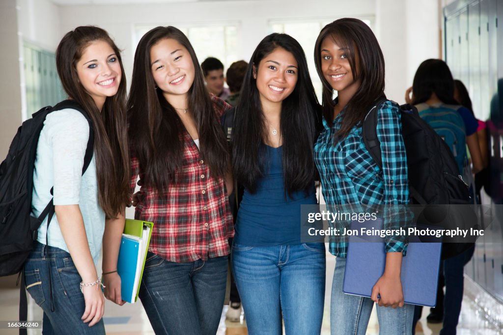 High school friends standing in corridor together