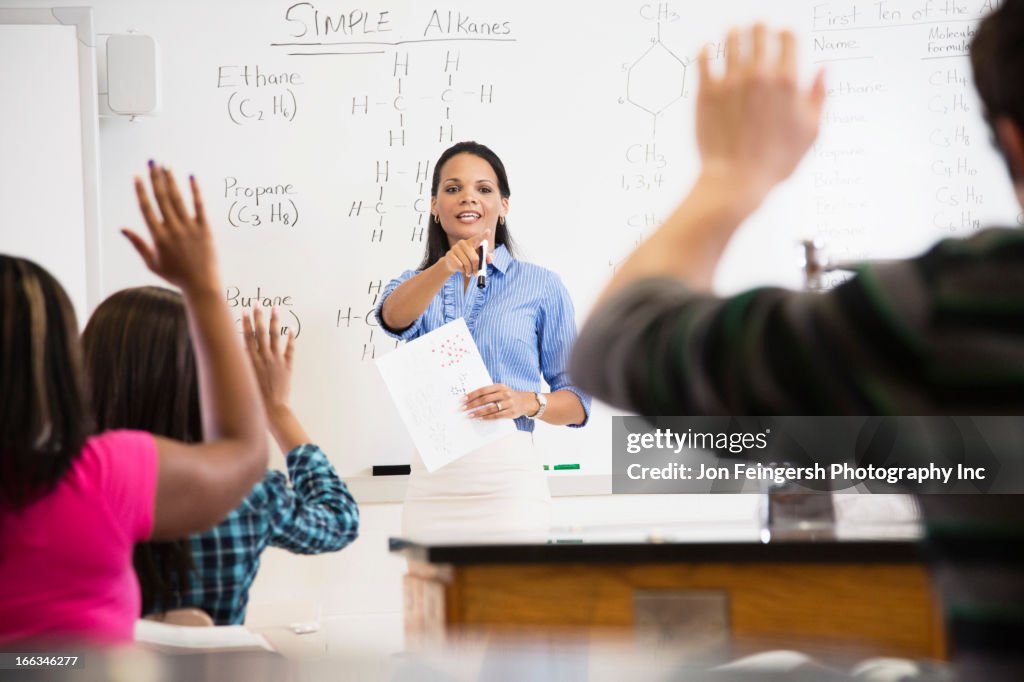 Black teacher talking to students in class room
