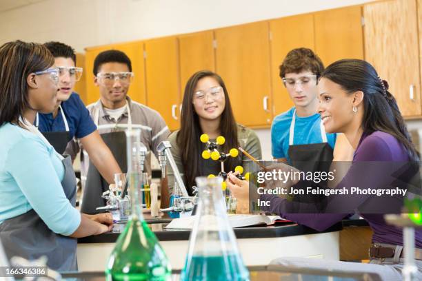 teacher explaining chemistry model to students - 16 year old male model stock pictures, royalty-free photos & images