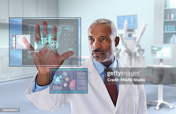 black doctor looking at digital display in doctor's office - robot surgery stock pictures, royalty-free photos & images
