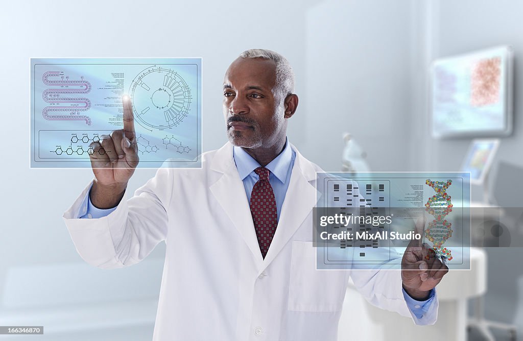 Black doctor looking at digital display in laboratory
