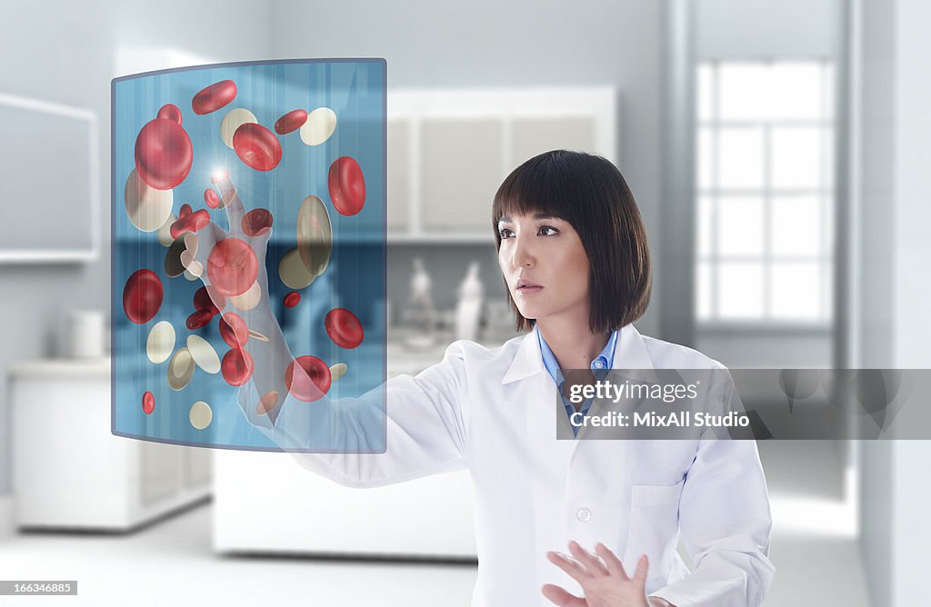 Mixed race doctor using digital display in doctor's office