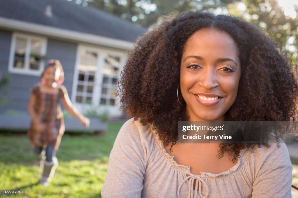 African American mother and daughter in backyard