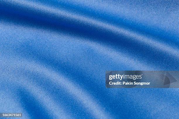 blue color sports clothing fabric football shirt jersey texture and textile background - jersey stockfoto's en -beelden