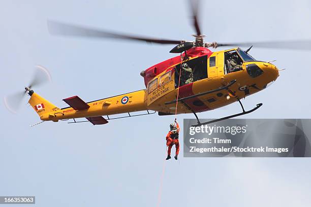 ch-146 griffon of the canadian forces during a joint search and rescue exercise with the german navy, kiel, germany. - rappelling stock pictures, royalty-free photos & images