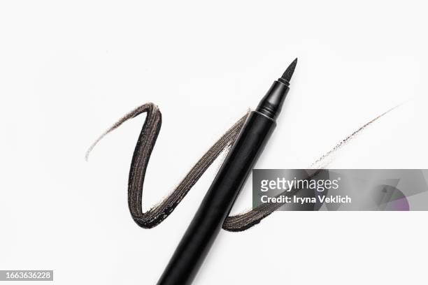 waved black smear of black eyeliner pencil or eyebrow pencil on white background, isolated. cosmetic make-up product for eye and eyelashes. - eyebrow pencil stock pictures, royalty-free photos & images