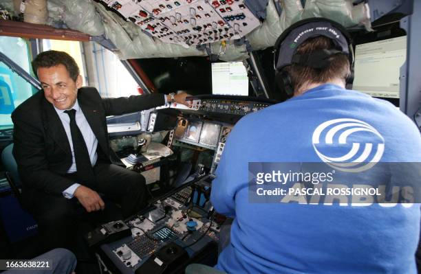 French President Nicolas Sarkozy sits in the cabin of a A330 Airbus in built, 18 May 2007 during a visit at the Airbus plant in Toulouse,...
