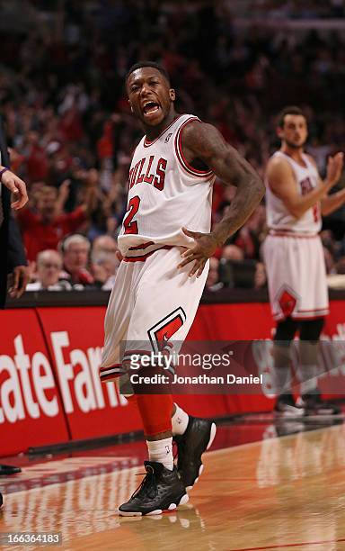 Nate Robinson of the Chicago Bulls celebrates hitting a three-point shot against the New York Knicks at the United Center on April 11, 2013 in...