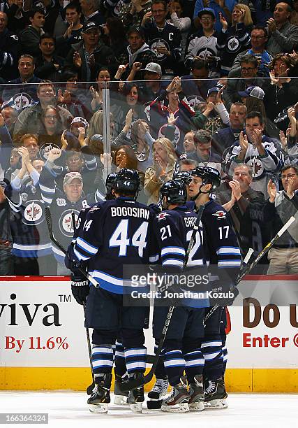 Zach Bogosian, Aaron Gagnon and James Wright of the Winnipeg Jets celebrate a third period goal against the Florida Panthers with teammates at the...
